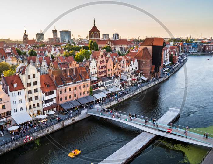 Gdansk, North Poland - August 13, 2020: Panoramic Aerial Shot Of Motlawa River Embankment In Old Town During Sunset Where People Can Be Seen Boating