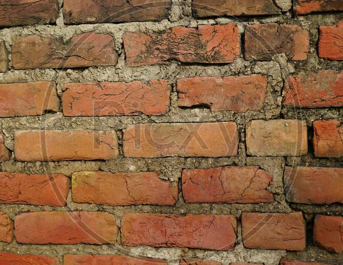 Infrastructure concept: Selective focus on Red brick wall texture, jointed with cement mortar.