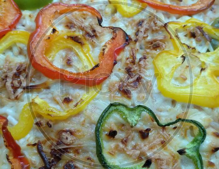 Veg cheese bake dish Closeup photo also look like Pizza