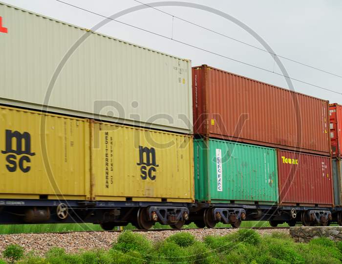 Indian logistic freight train carrying cargo Container on railway track. Indian railway concept.