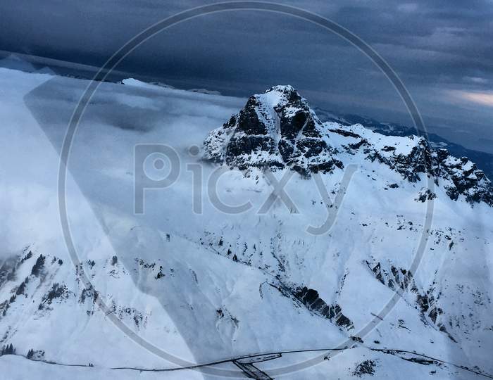 Snow covered mountains in Austria during a flight 10.2.2017with a propeller plane