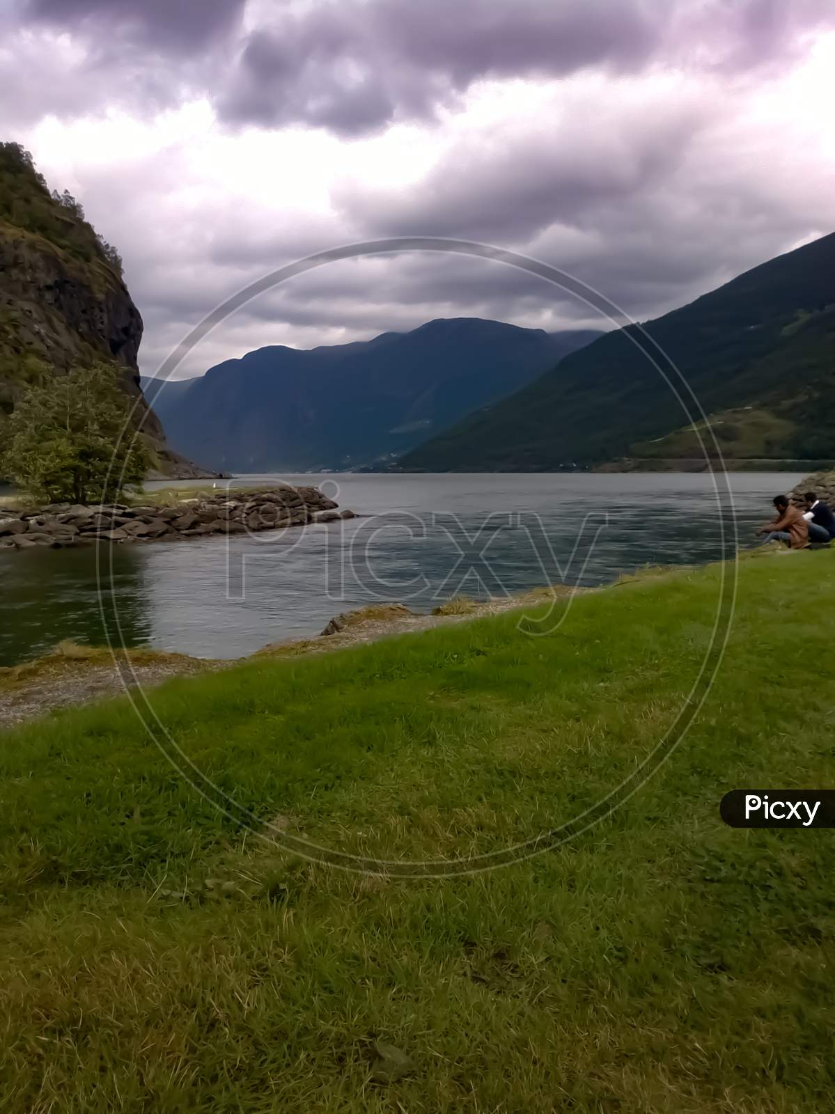 View Of Lake And Mountains Under Cloudy Sky Near Flam Cruise Port Norway