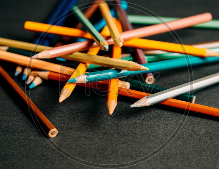 A Group Of Colorful Pencils Lying On Each Other