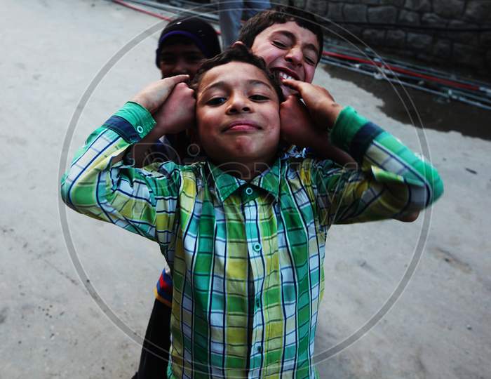 kids from leh posing towards the camera