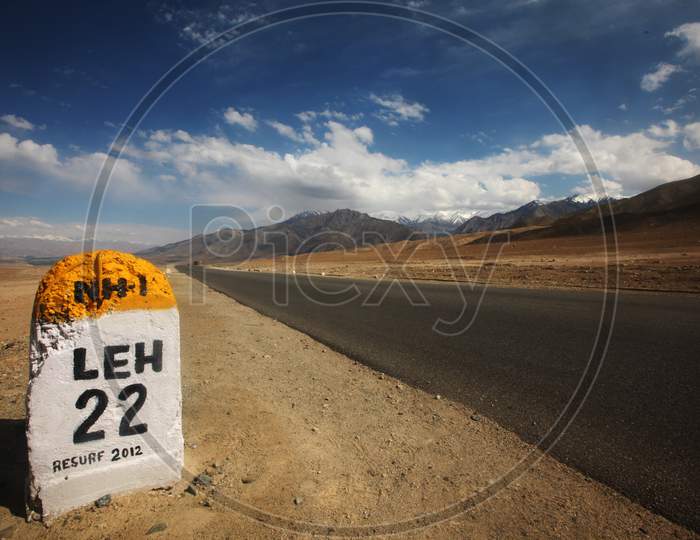 Road in Leh with Road Sign Board and beautiful mountains