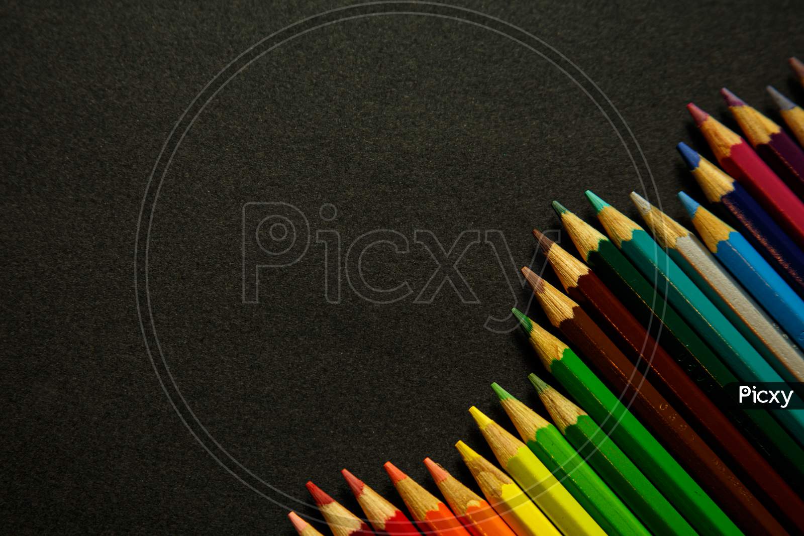 Colorful Pencil Forming Spikes Over A Dark Background
