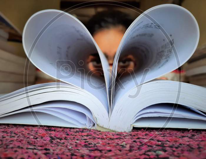 Girl Making Heart Shape Of Book Pages And Showing Love On Book Lovers Day
