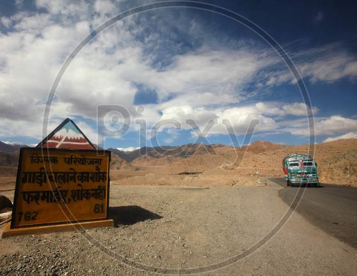 Roads in Leh with Road Sign Board and beautiful mountains