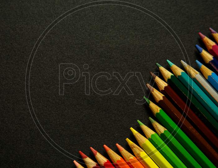 Colorful Pencil Forming Spikes Over A Dark Background