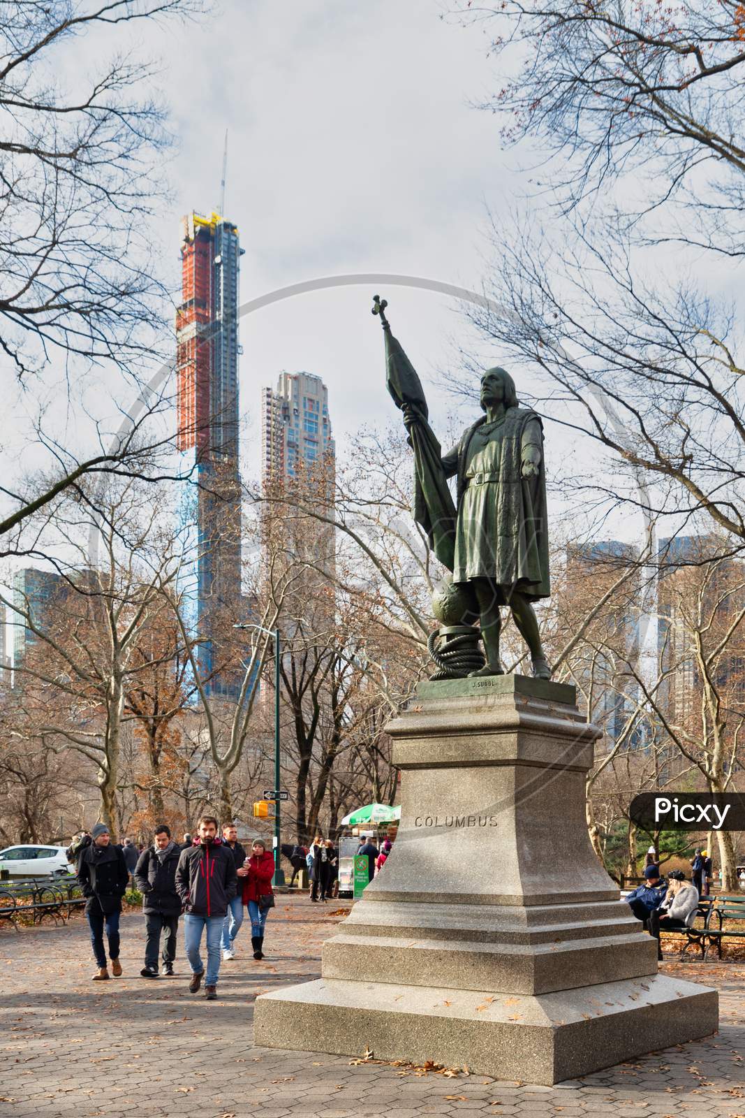 Christopher Columbus Statue (by  Jeronimo Suol)  in Central park New York city daylight view with trees and clouds in sky