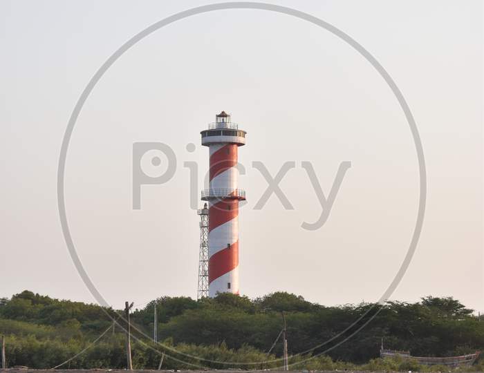 The lighthouse is red and white paints colored.
