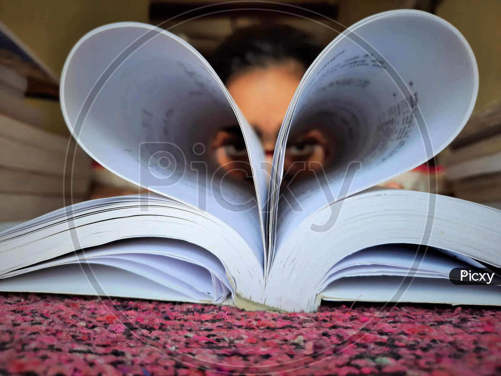 Girl Making Heart Shape Of Book Pages And Showing Love On Book Lovers Day