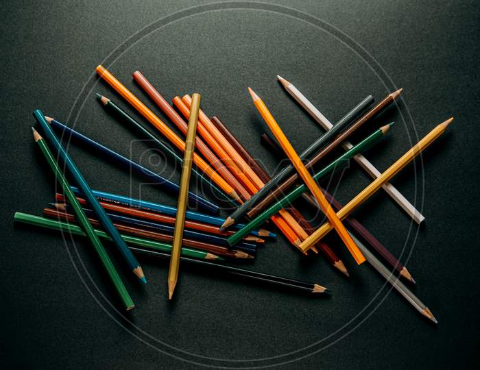 Colorful Pencils In The Middle Of A Dark Background