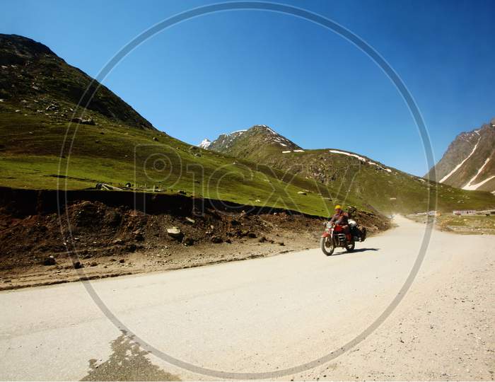 Bike Rider Riding Across a Highway Of Ladakh