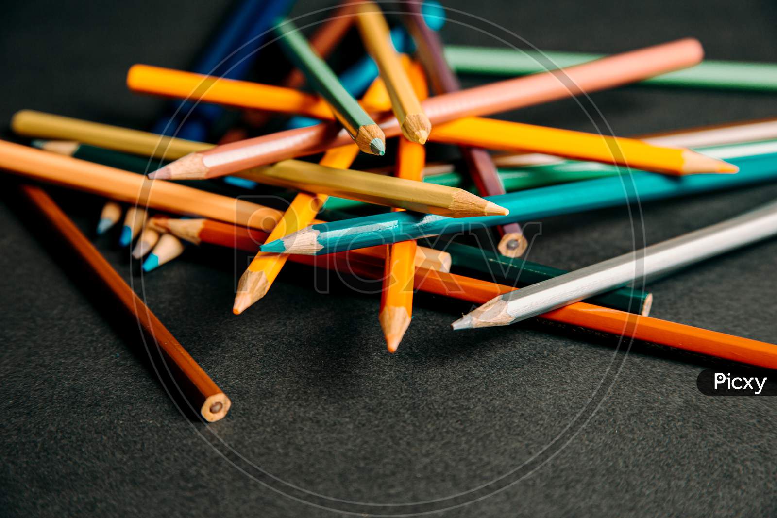 A Group Of Colorful Pencils Lying On Each Other
