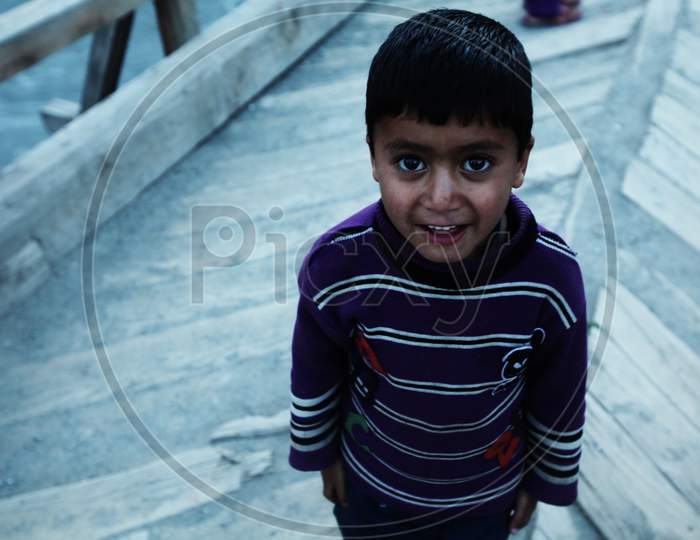 a kid from leh posing towards the camera