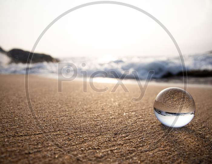 Lensball reflection of ocean and beach Wave
