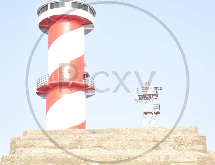 The lighthouse is red and white colored.