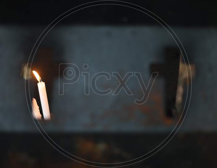 Lightened Candle through a Christian Pendant