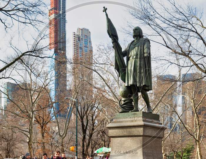 Christopher Columbus Statue (by  Jeronimo Suol)  in Central park New York city daylight view with trees and clouds in sky