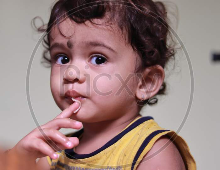 A Beautiful Indian Child Eats Semia