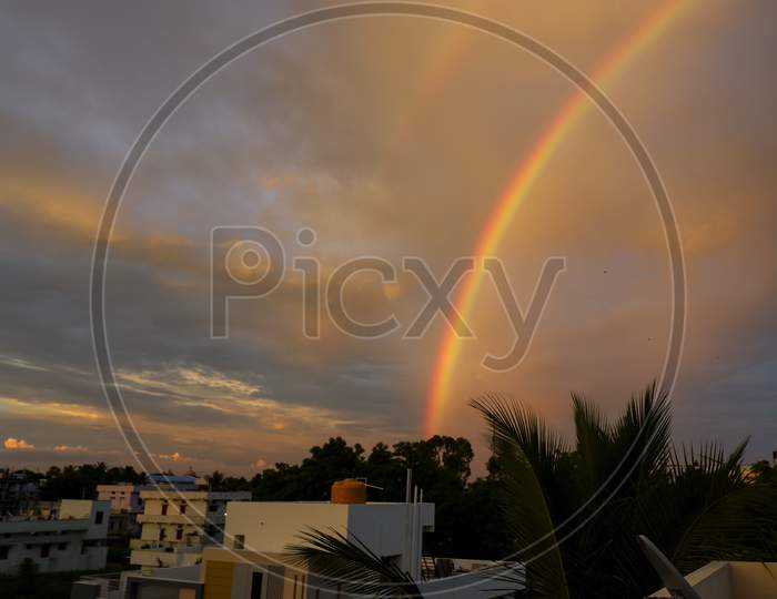 Beautiful Rainbow On Sky, Clouds In Evening At City