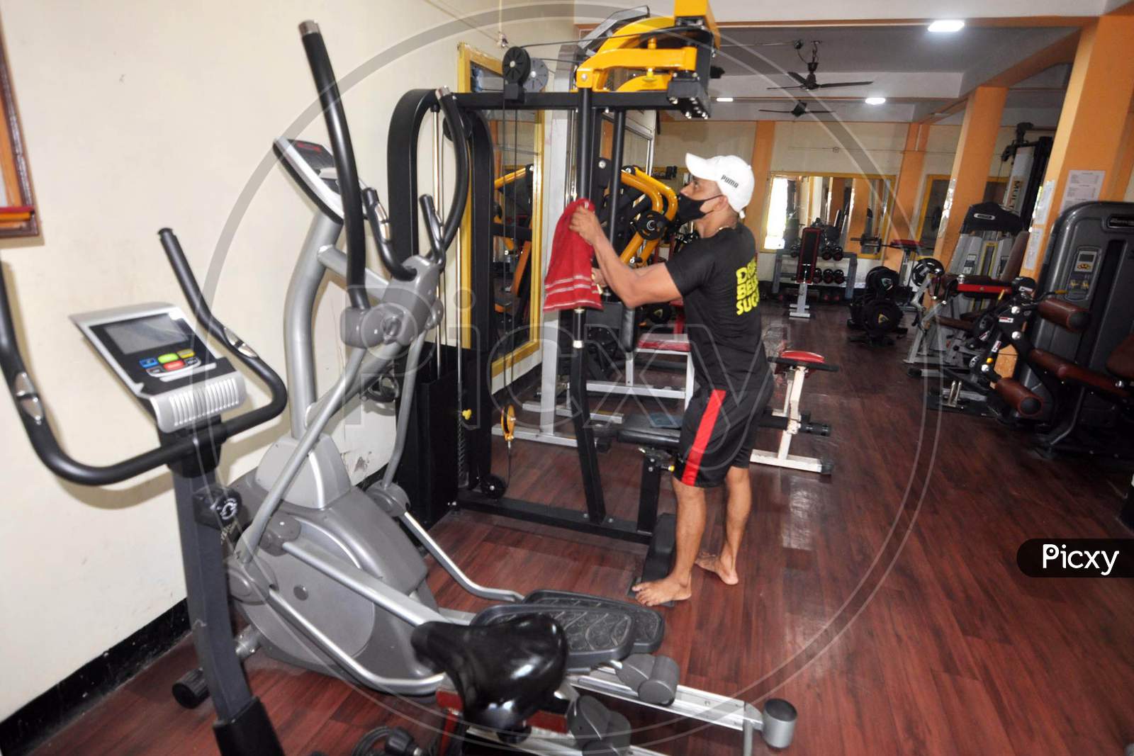 A Gym Instructor Sanitizes A Gym Before Its Reopening After Authorities Eased Lockdown Restrictions That Were Imposed To Slow The Spread Of The Coronavirus Disease (Covid-19), In Guwahati On August 3,2020