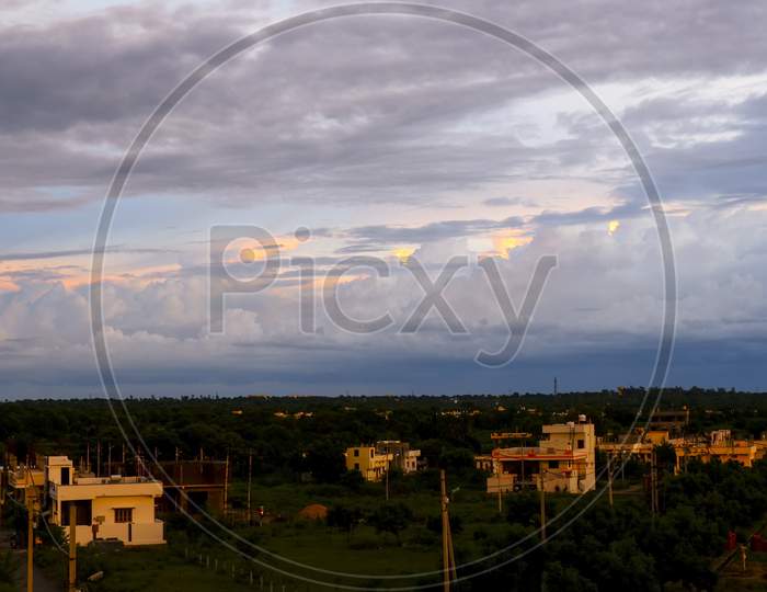 Sunset With Cloudy Landscape Rural Buildings