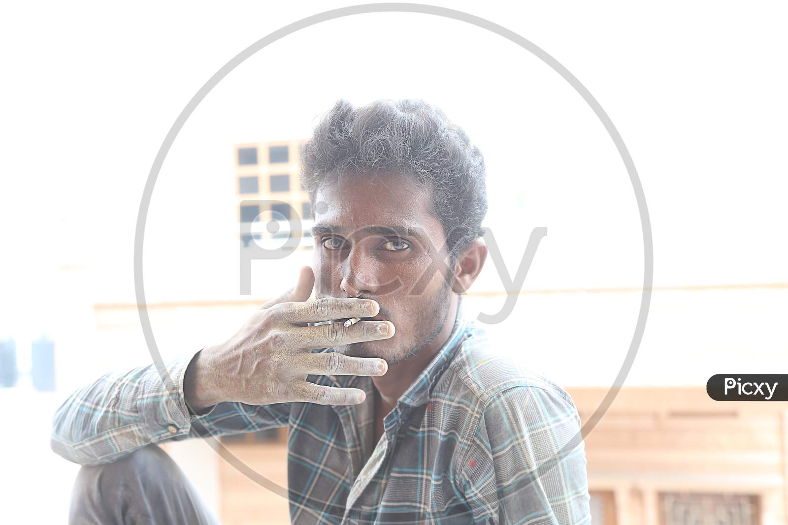 Jodhpur, Rajasthan, India, 20Th September 2020: Poor Indian Male Labour Worker Smoking Cigarette Looking At The Camera, Daytime, Unemployment.