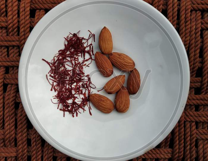 saffron and almonds are decorated in a dish.