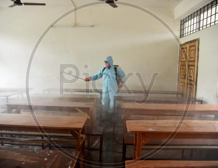 Municipal worker wearing personal protective equipment (PPE) sprays disinfectant to sanitize a  school  to prevent the spread of the coronavirus disease (Covid-19) In Nagaon district of Assam on August 30,2020.