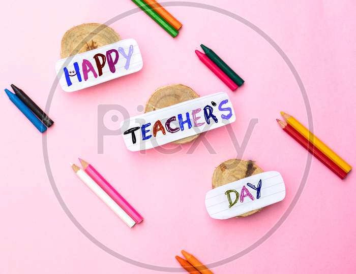 Happy Teacher's Day Creative Photo With Color Pencils Isolated On Pink Background In Vertical Orientation