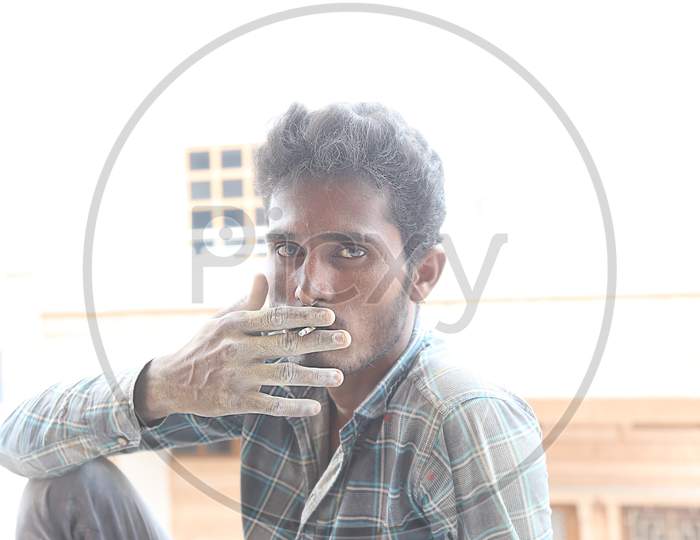 Jodhpur, Rajasthan, India, 20Th September 2020: Poor Indian Male Labour Worker Smoking Cigarette Looking At The Camera, Daytime, Unemployment.