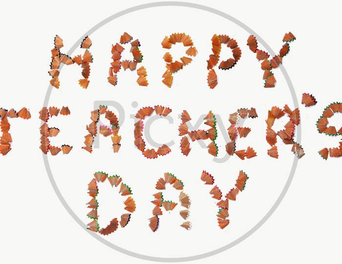 Happy Teacher'S Day Wish Written With Pencil Shavings Parts On White Background