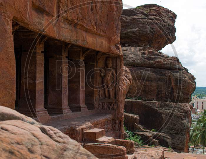 Ancient stone pillars carving inside a single red sandstone Rocky mountain, having old indian architecture.