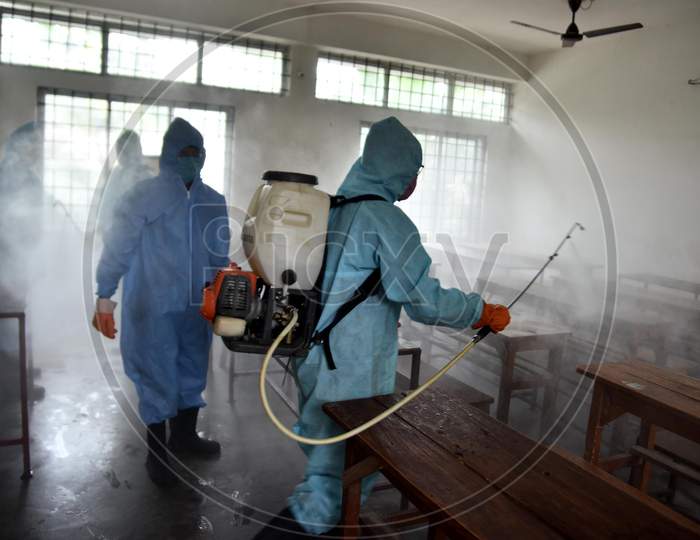 Municipal worker wearing personal protective equipment (PPE) sprays disinfectant to sanitize a  school  to prevent the spread of the coronavirus disease (Covid-19) In Nagaon district of Assam on August 30,2020.