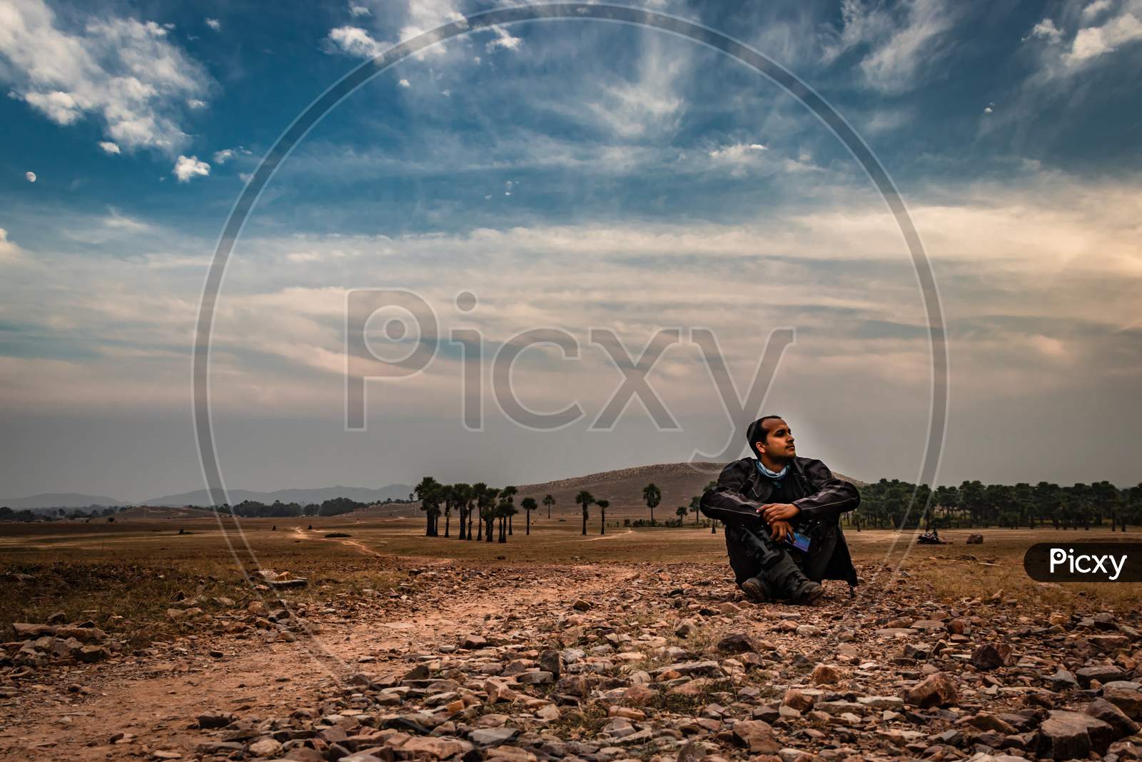 Man Sitting On Ground In Isolated Loneliness