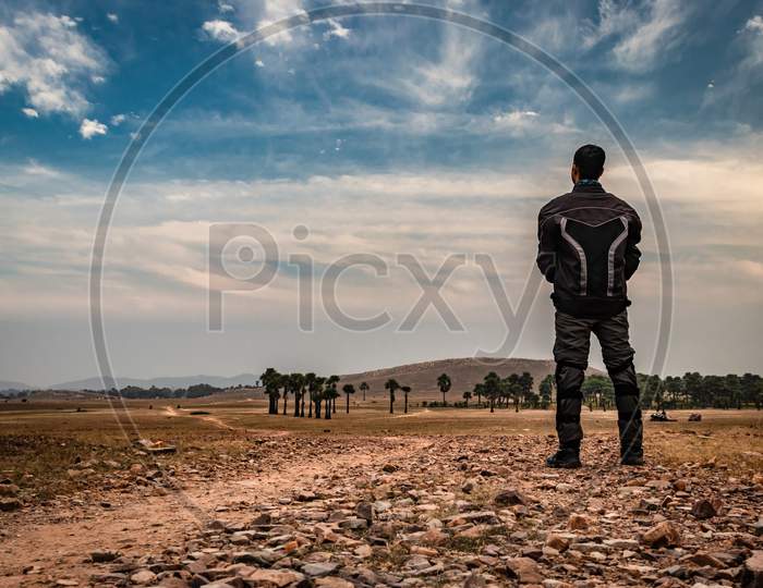 Motorcycle Rider Standing On Tarmac Road Isolated