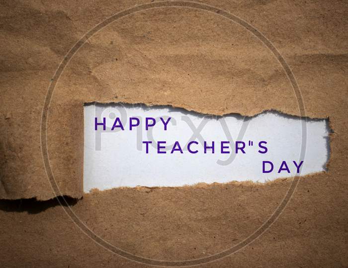Happy Teacher'S Day Wish Written Amid Torn Paper
