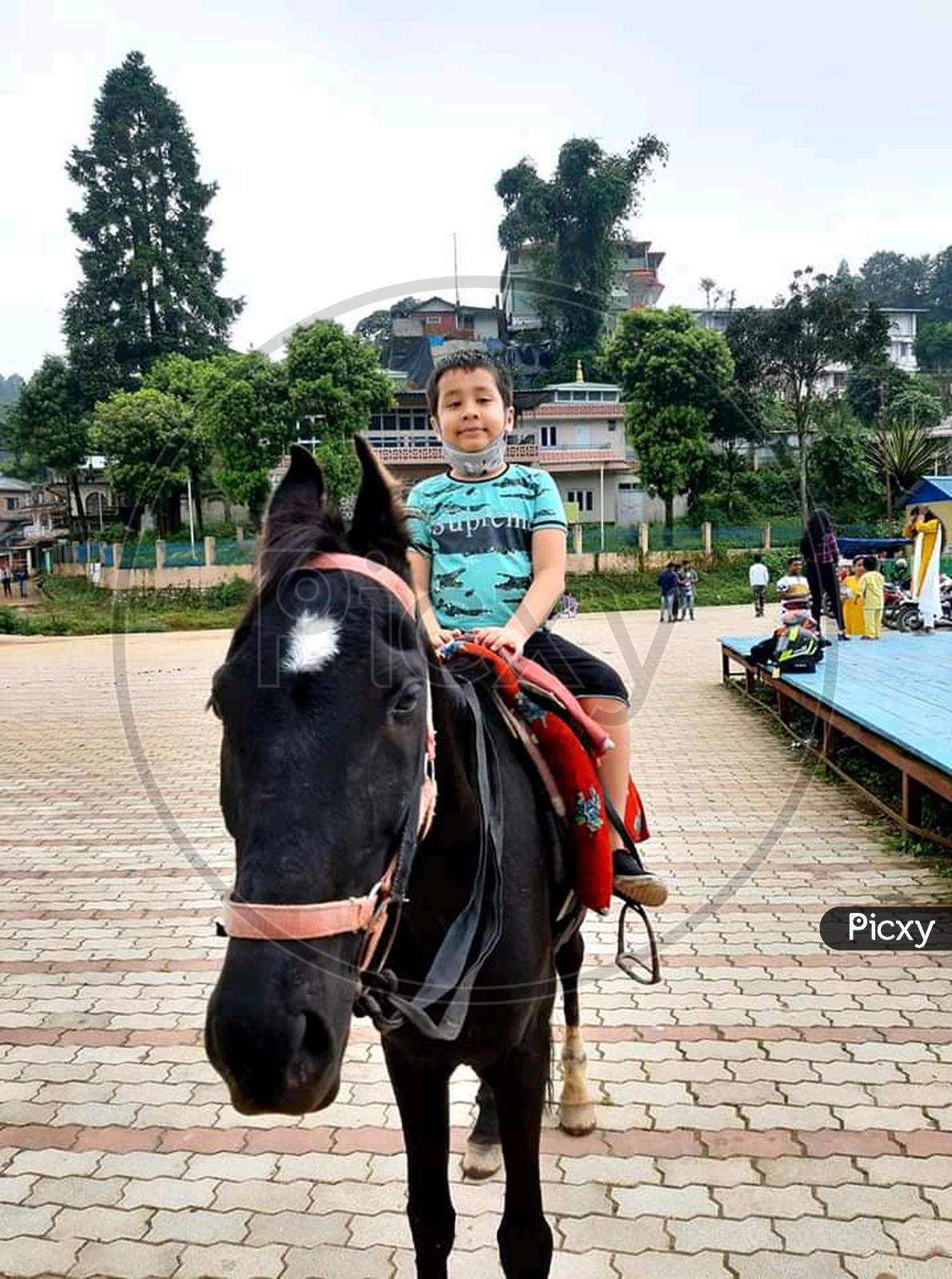 A boy riding horse