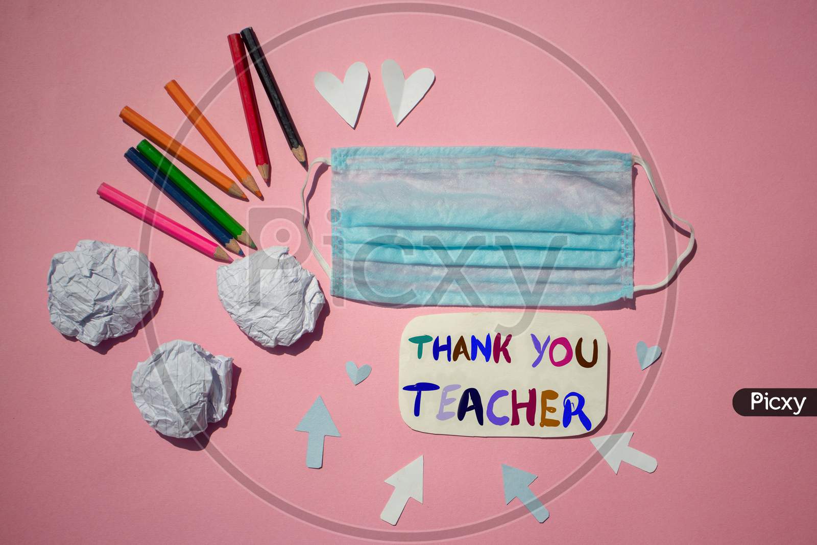 Thank You Teacher Written On Paper Note With Medical Face Mask And Color Pencils, Happy Teacher's Day Conceptual Photo