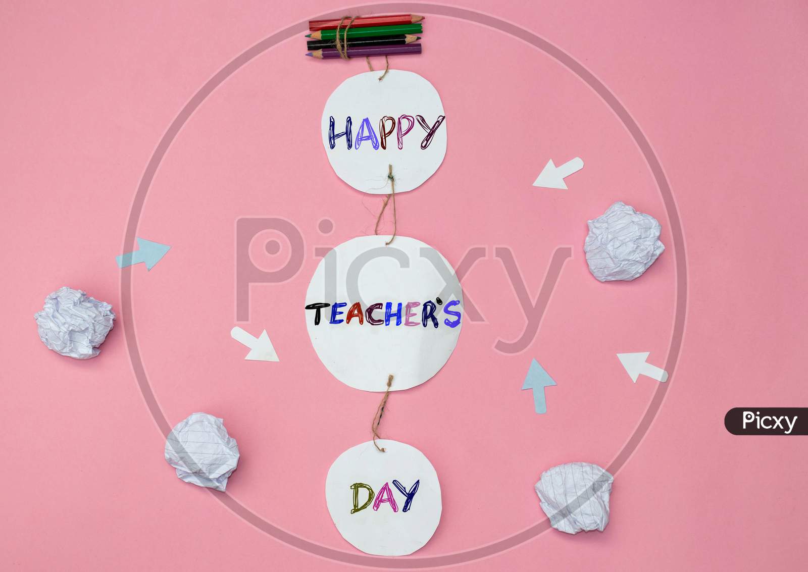 Happy Teacher's Day Creative Photo With Color Pencils And Crumpled Paper Balls On Pink Background, Perfect For Wallpaper