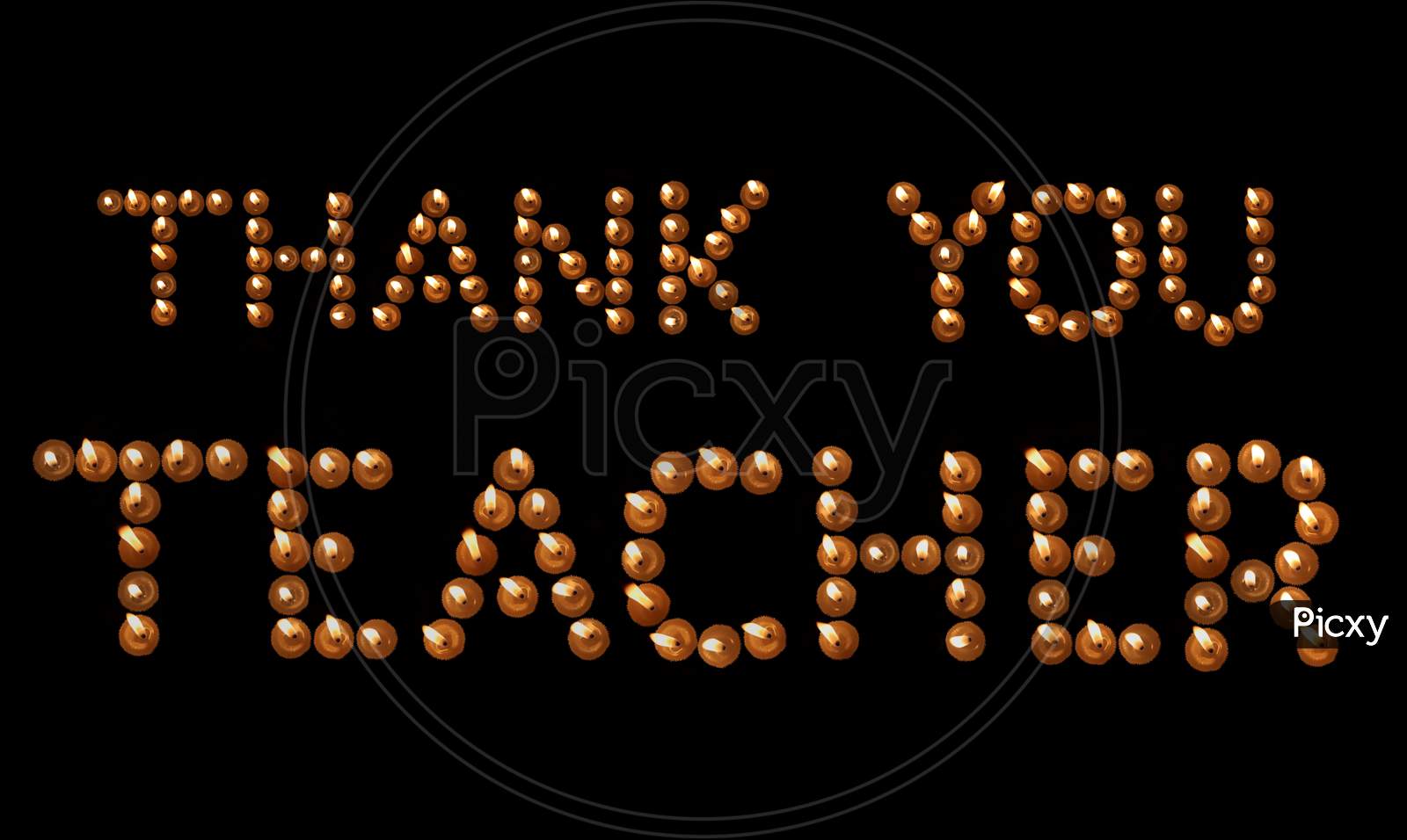 Thank You Teacher Written With Burning Candles In Black Background, Happy Teachers' Day Conceptual Photo