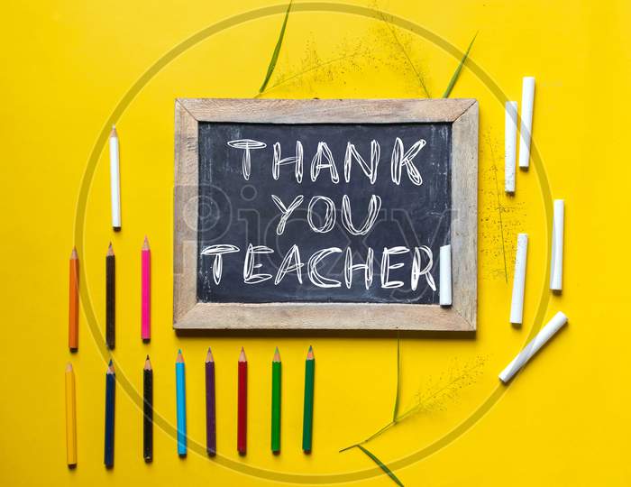 Thank You Teacher Written On Slate Board With Chalk And Color Pencils, Happy Teacher's Day Conceptual Photo
