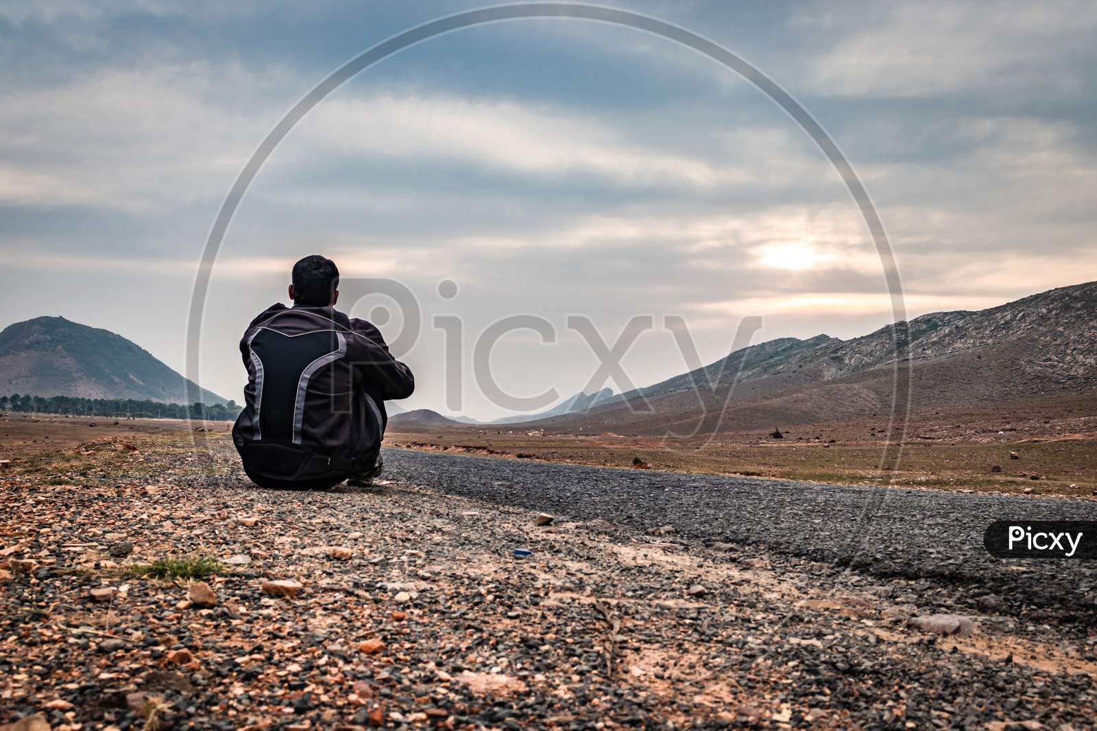 Man Sitting On Ground In Isolated Loneliness