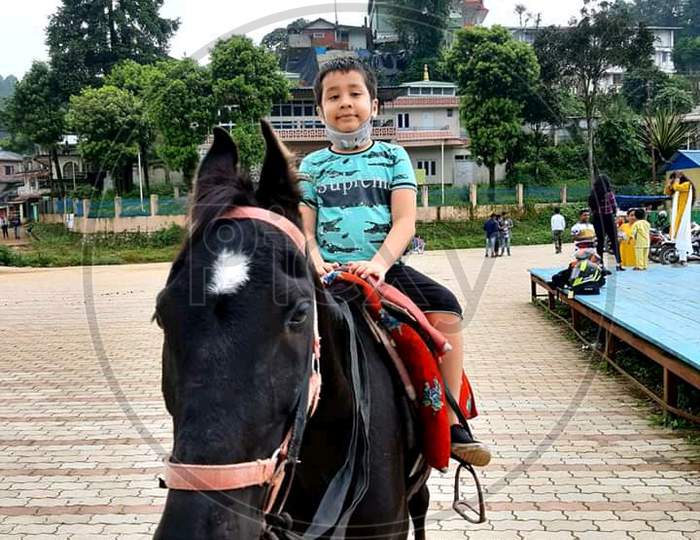 A boy riding horse