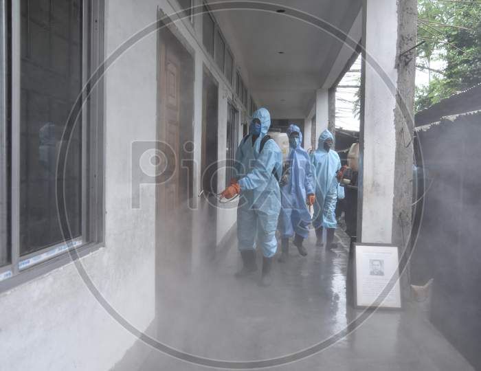 Municipal workers wearing personal protective equipment (PPE) spray disinfectant to sanitize a  school  to prevent the spread of the coronavirus disease (Covid-19) In Nagaon district of Assam on August 30,2020.