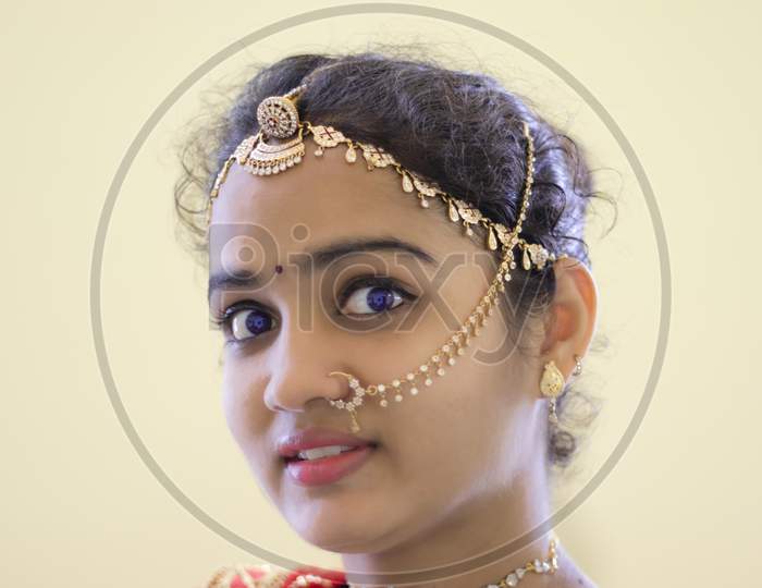 ,A Beautiful Young Hindu Woman Face And Wore Gold Ornaments