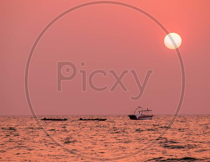 beautiful view of a sunsetat  goa sea and a boat
