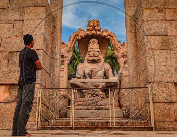 Man Witnessing At Narasimha Lakshmi Temple Hampi Antique Stone Art Close Up Shot